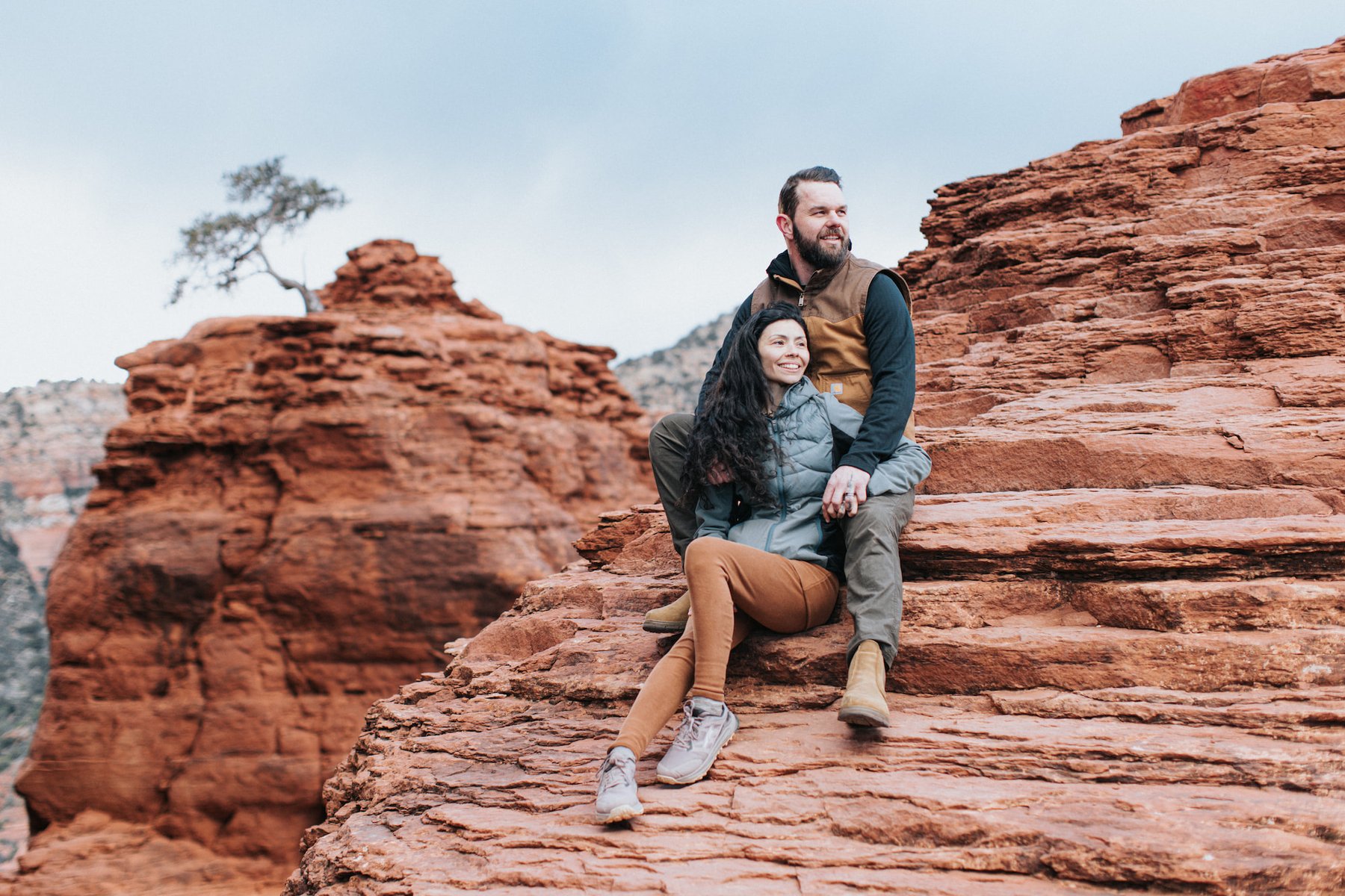 Couple sitting together on Sedona red rock